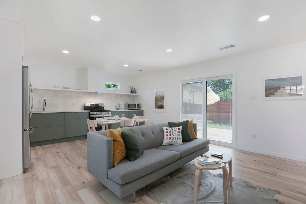 906 East Leslie Circle, Unit A Austin, TX 78721 - Photo 12 of 16 a view of kitchen with kitchen island microwave and cabinets