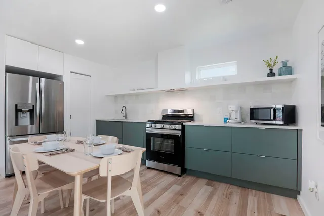 a kitchen with a sink cabinets and stainless steel appliances