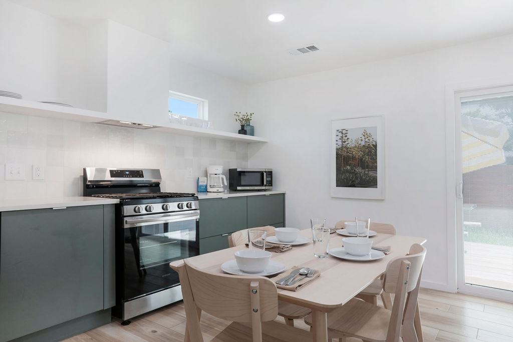 906 East Leslie Circle, Unit A Austin, TX 78721 - Photo 14 of 16 a kitchen with a table and chairs in it