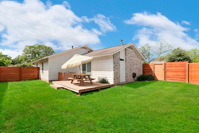 a front view of house with yard and trees