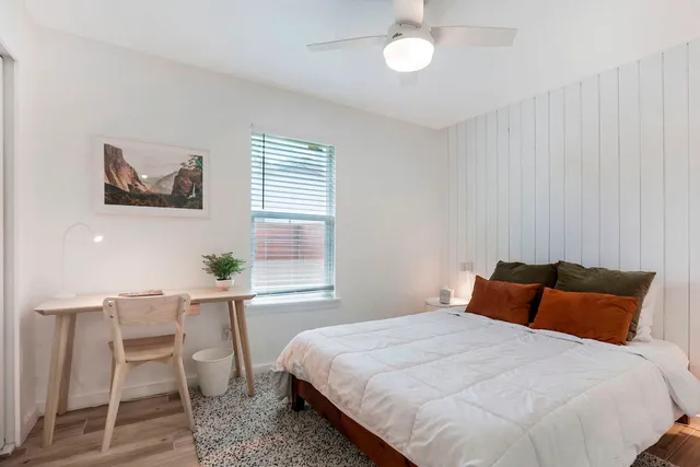 a bedroom with a bed and a window