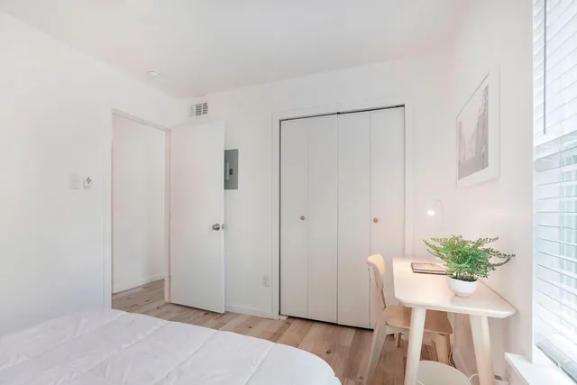 a bedroom with a bed and a chair