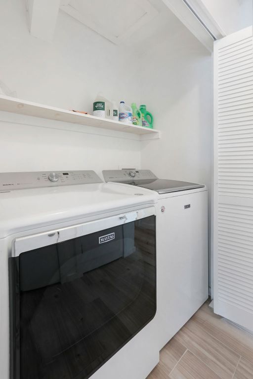 906 East Leslie Circle, Unit A Austin, TX 78721 - Photo 5 of 16 a utility room with a sink a potted plant and wooden floor