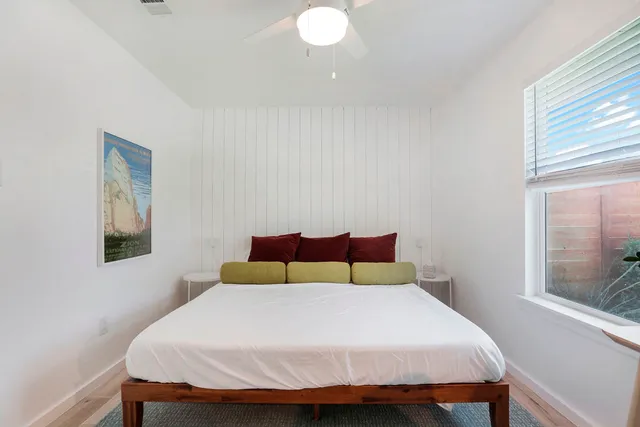 a bedroom with a bed and glass window