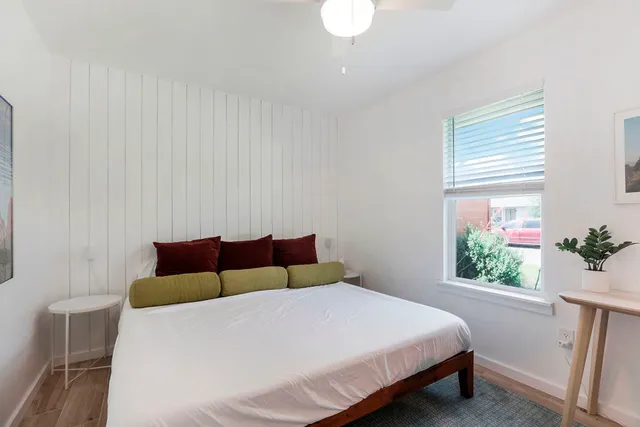 a bedroom with a bed and a window