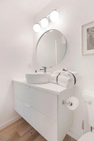a bathroom with a sink mirror and vanity