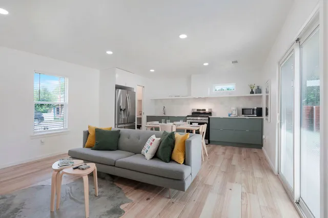 a living room with furniture and kitchen view