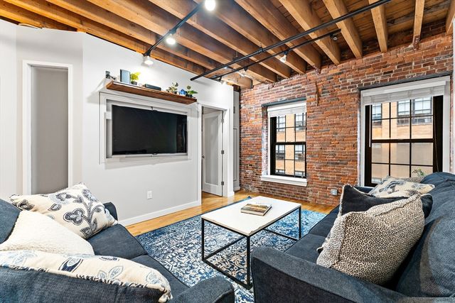 a living room with furniture ceiling fan and a window
