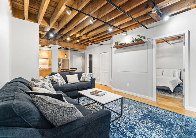 a living room with furniture and a rug