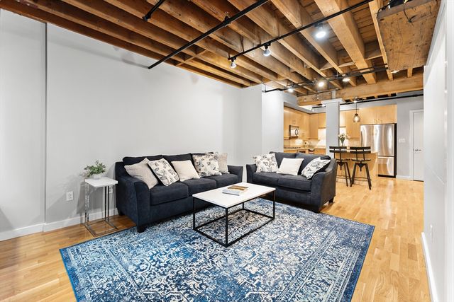 a living room with lots of furniture and a rug