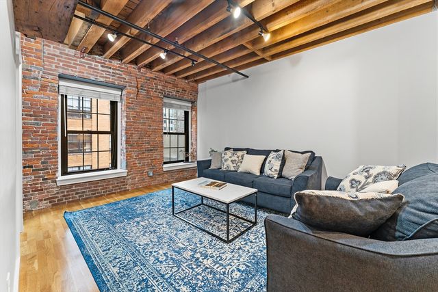 a living room with furniture and a rug