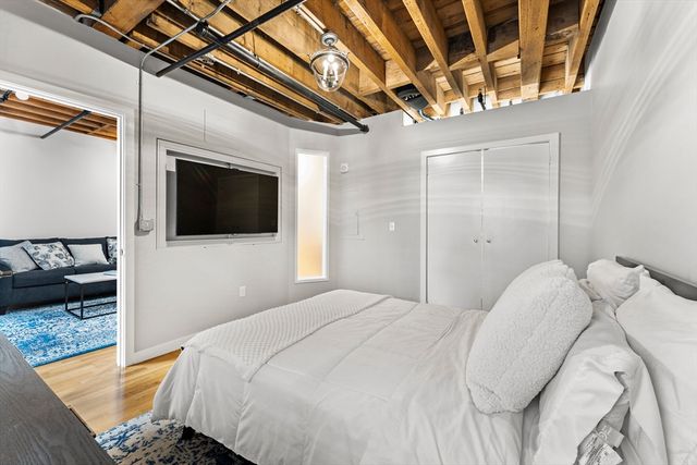 a bedroom with a bed and a television