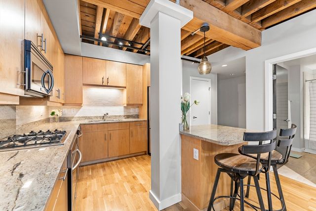 a kitchen with stainless steel appliances granite countertop a stove and a refrigerator