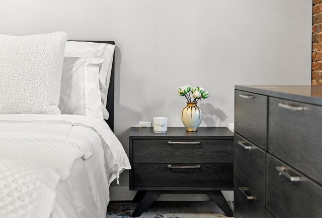 a bed sitting in a bedroom next to a window