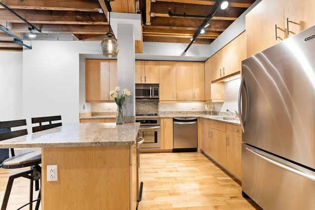 a kitchen with refrigerator and microwave