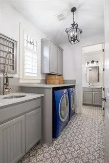 a utility room with a sink a washer and dryer