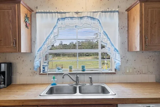 a kitchen with a sink and a window