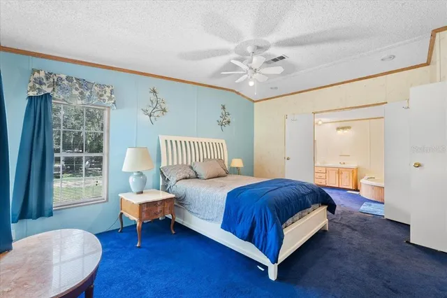 a spacious bedroom with a bed and window