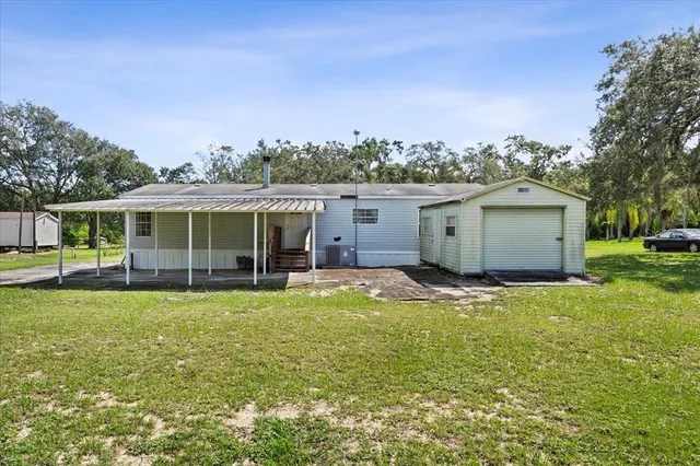 a view of a house with a yard and sitting area