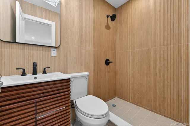 a bathroom with a sink a toilet and shower curtain