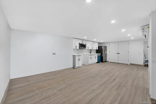 a view of a kitchen with a sink and a refrigerator