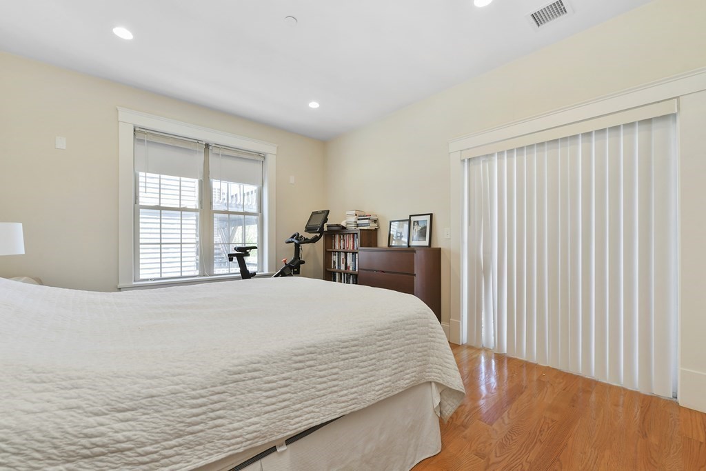 264 Athens Street, Unit 5 Boston, MA 02127 - Photo 10 of 18 a bed sitting in a spacious bedroom next to a window