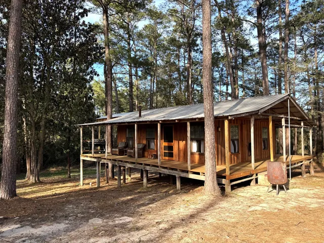 a view of a house with wooden floor and outdoor seating