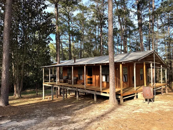a view of a house with wooden floor and outdoor seating