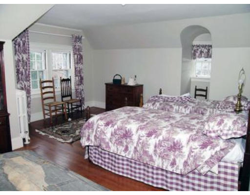 46 Welch Road Brookline, MA 02445 - Photo 13 of 15 a bedroom with a bed and a table in it