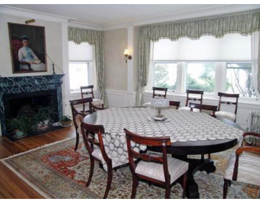 46 Welch Road Brookline, MA 02445 - Photo 7 of 15 a dining room with furniture a rug and a fireplace