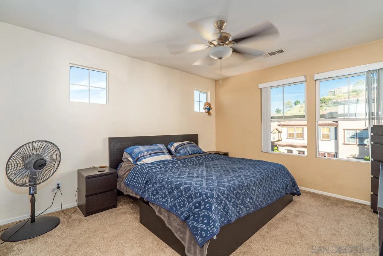 1113 Calabria Street Santee, CA 92071 - Photo 13 of 31 a bedroom with a bed a chandelier and a window