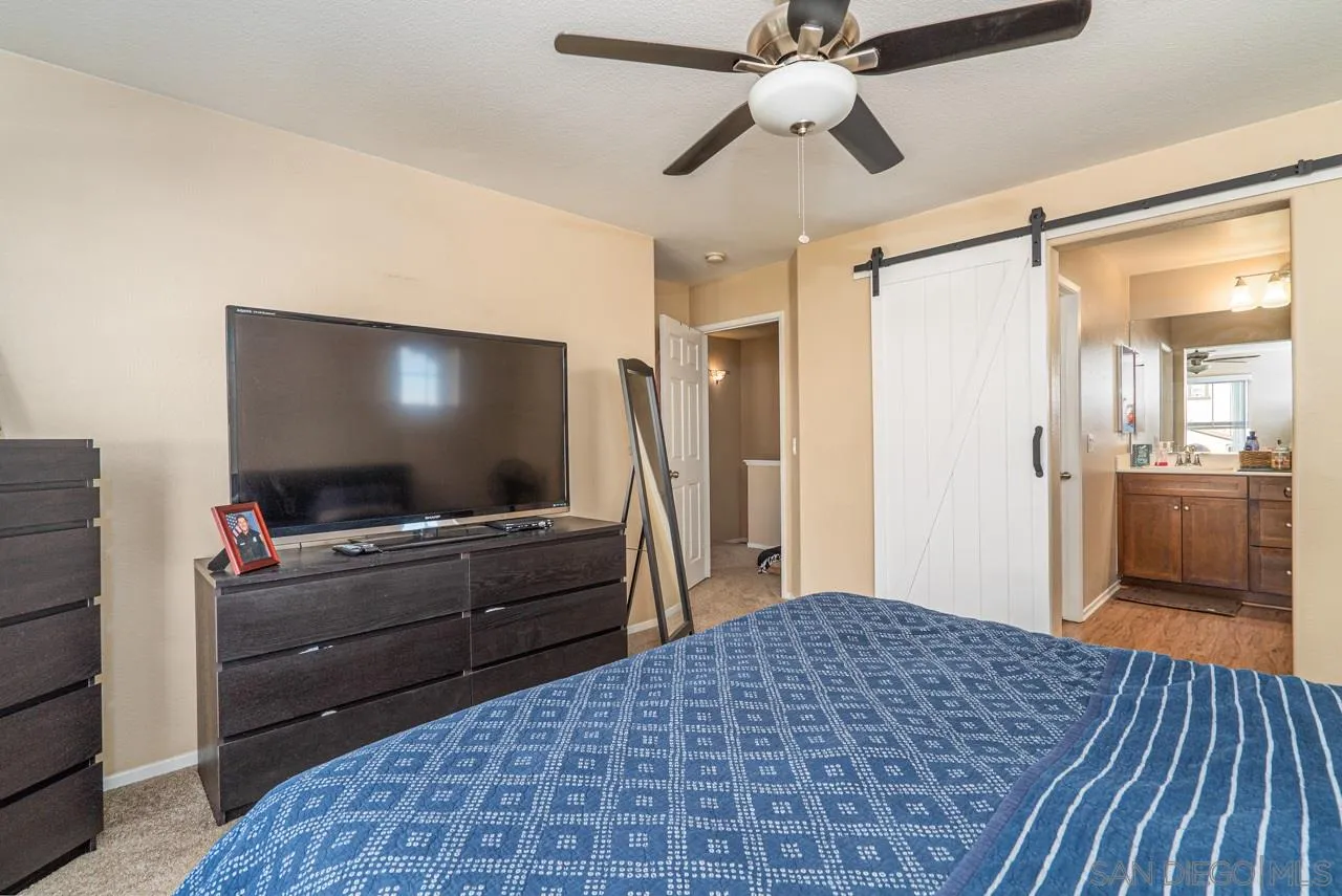 1113 Calabria Street Santee, CA 92071 - Photo 14 of 31 a bedroom with a bed and a flat screen tv