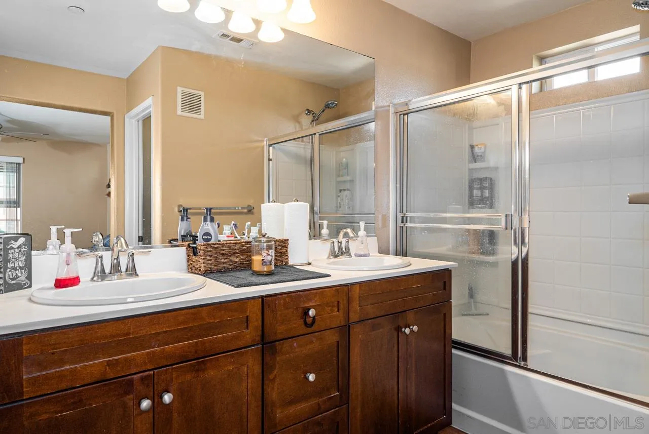 1113 Calabria Street Santee, CA 92071 - Photo 15 of 31 a bathroom with a double vanity sink and mirror with shower