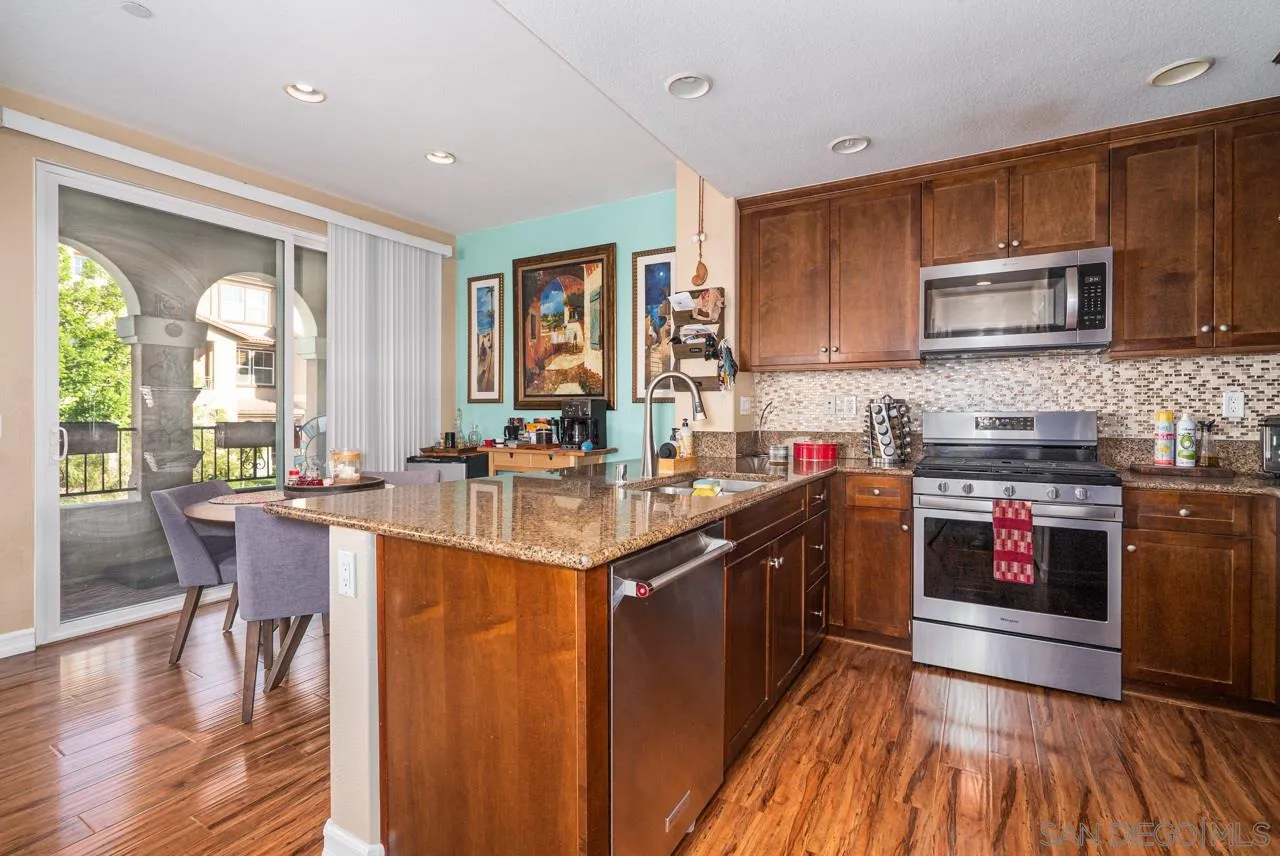 1113 Calabria Street Santee, CA 92071 - Photo 8 of 31 a kitchen with stainless steel appliances granite countertop sink stove top oven and cabinets
