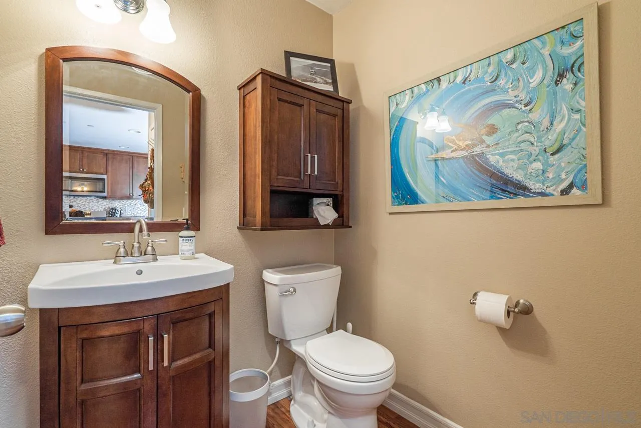 1113 Calabria Street Santee, CA 92071 - Photo 10 of 31 a bathroom with a toilet a sink and mirror