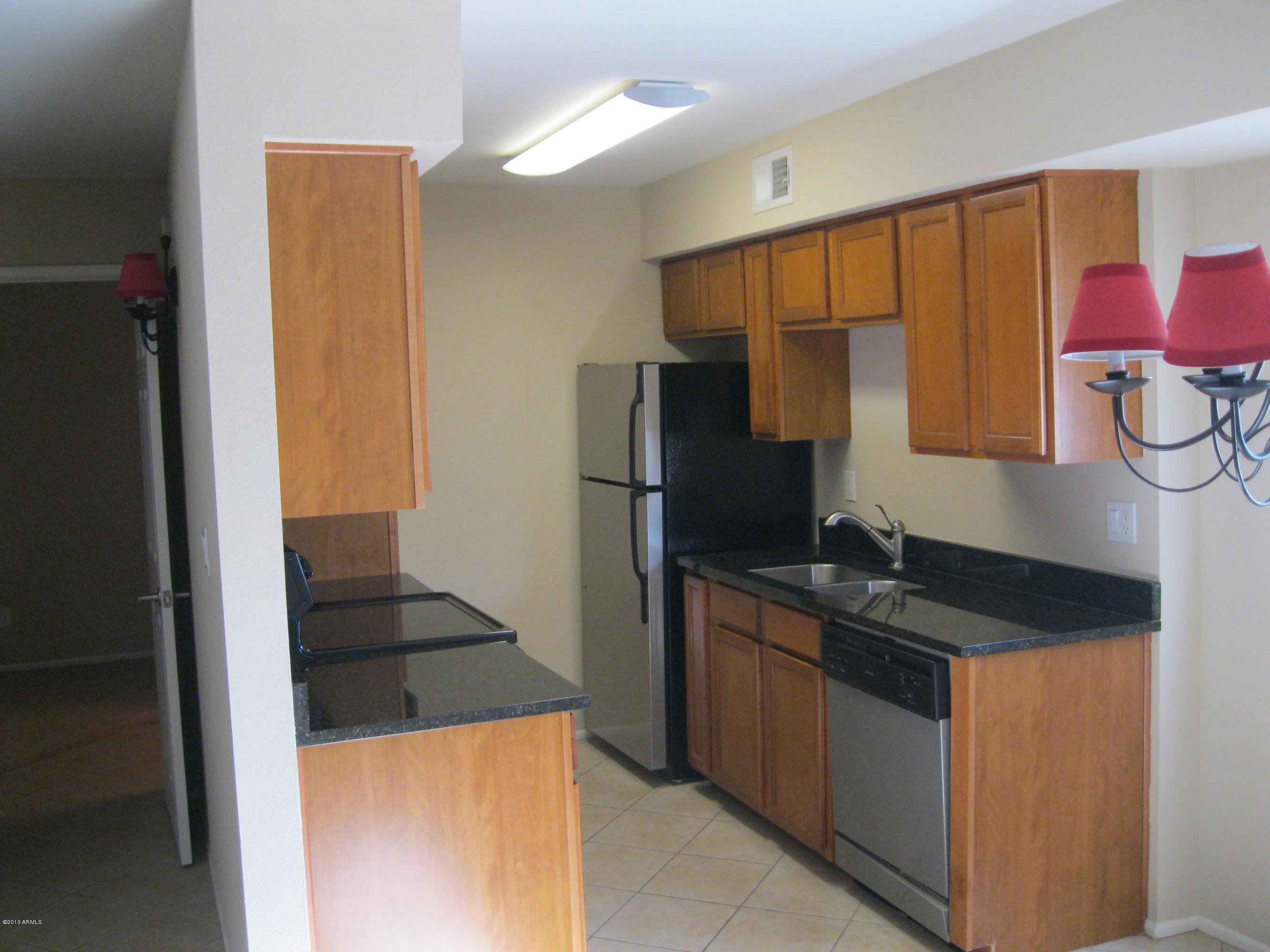 a kitchen with a refrigerator and a sink
