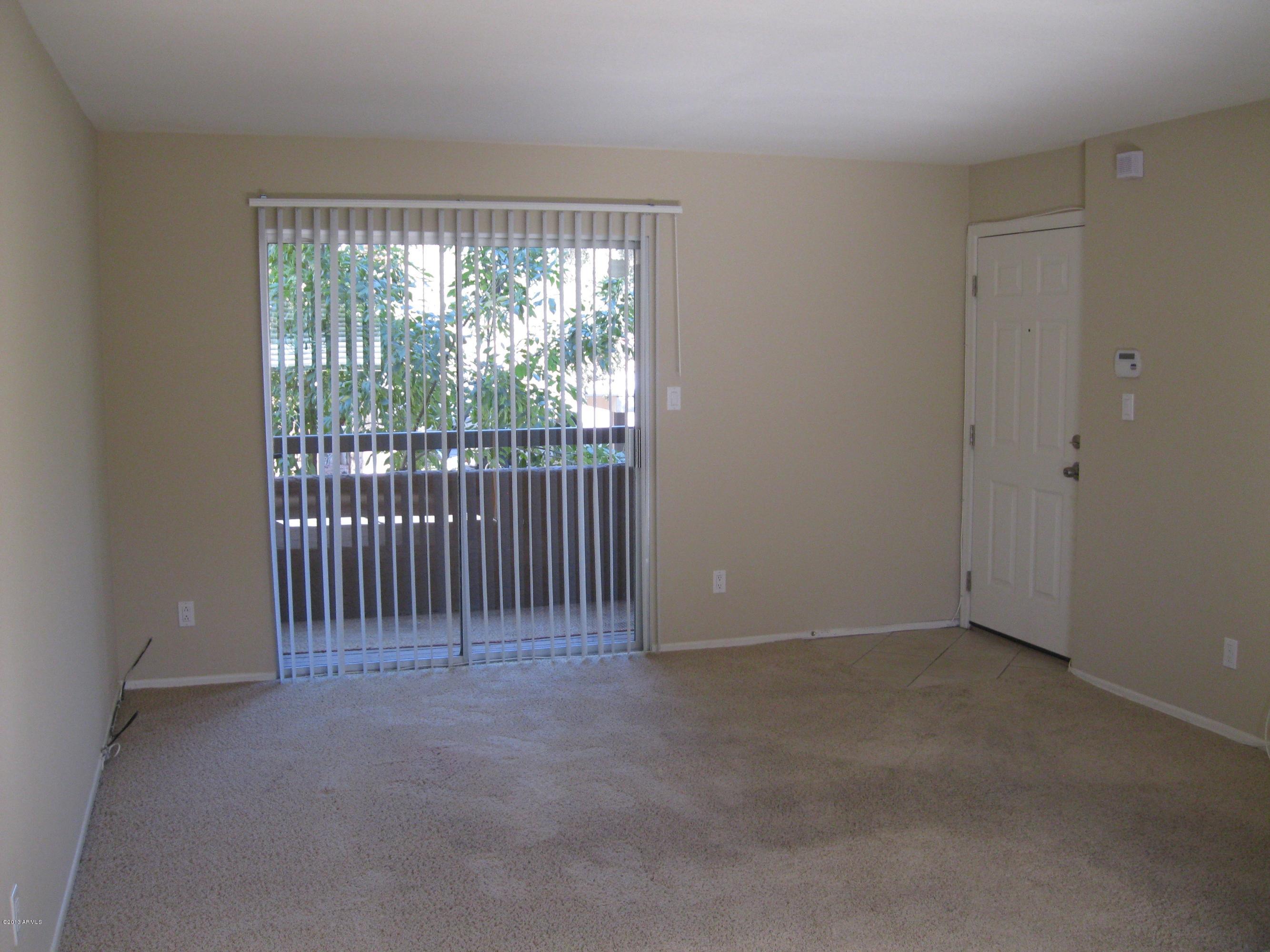 2625 East Indian School Road, Unit 229 Phoenix, AZ 85016 - Photo 2 of 11 a view of an empty room with floor to ceiling window