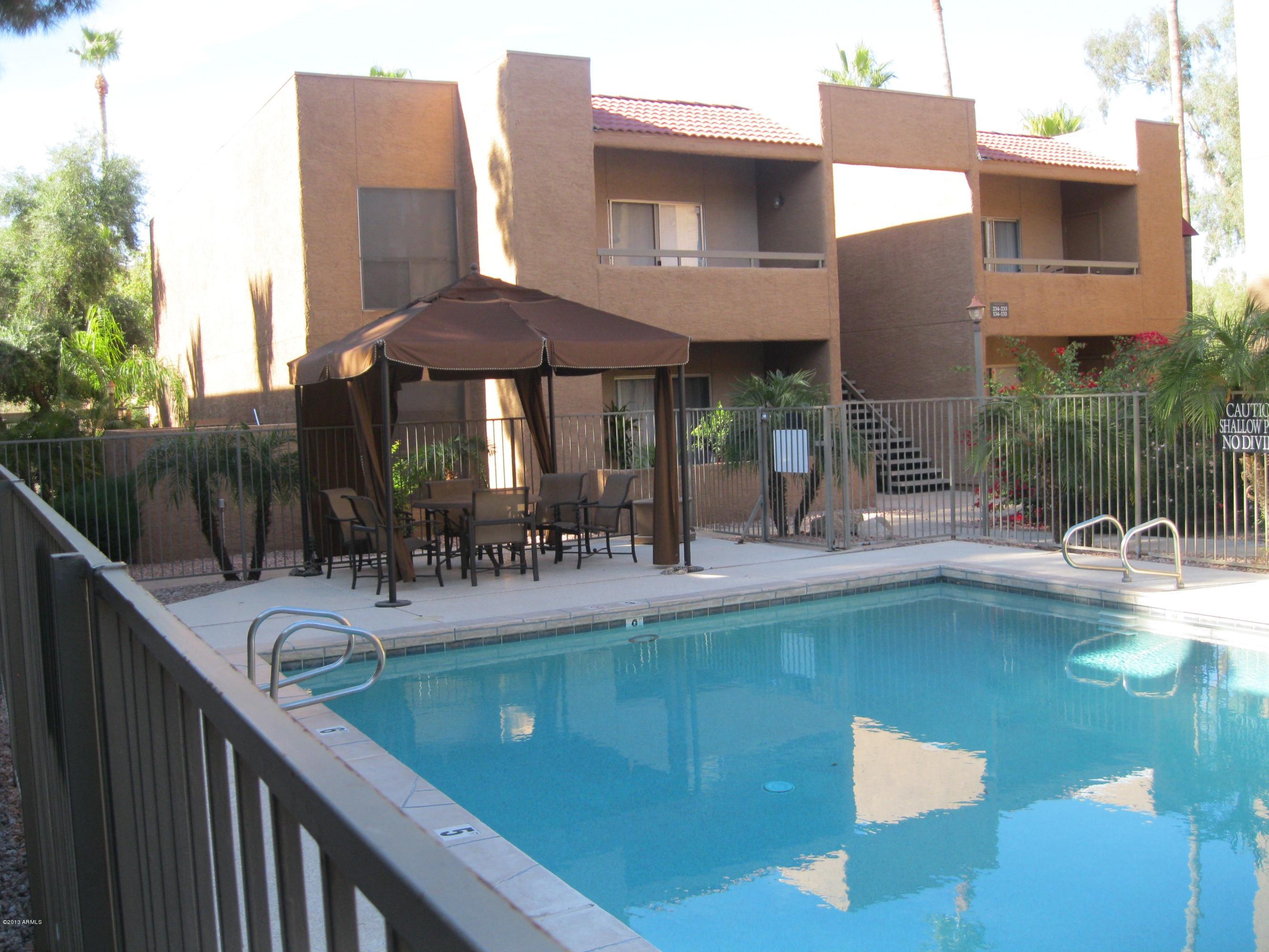 2625 East Indian School Road, Unit 229 Phoenix, AZ 85016 - Photo 8 of 11 a view of a house with pool and chairs