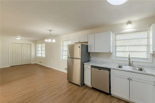 a kitchen with a refrigerator a sink and cabinets