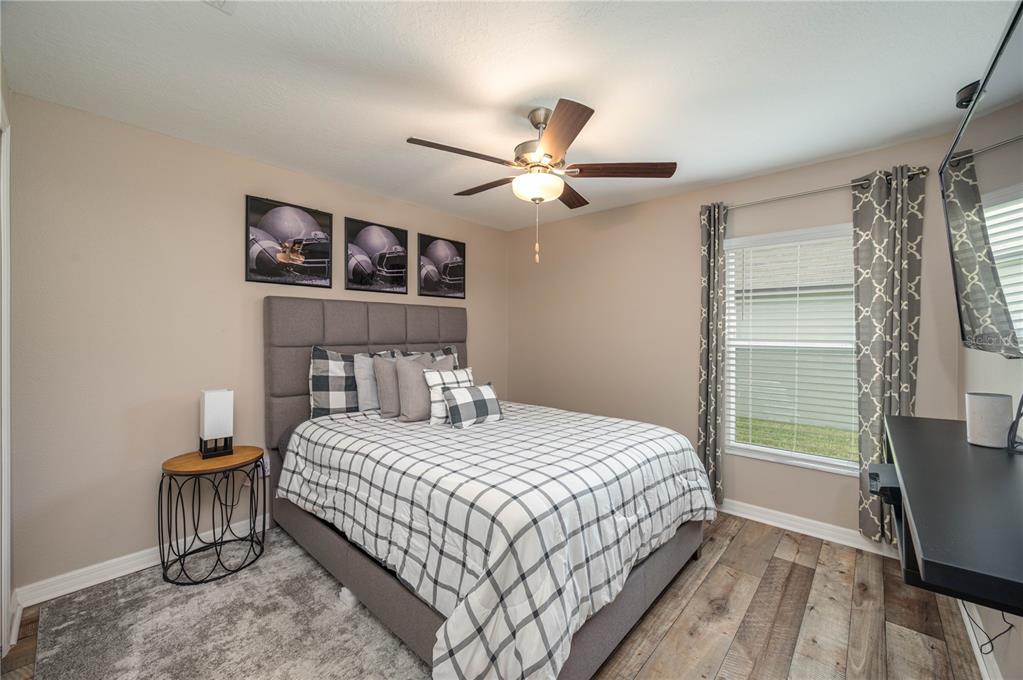 2958 Flying Blackbird Road Bartow, FL 33830 - Photo 17 of 28 a bedroom with a bed and a chandelier