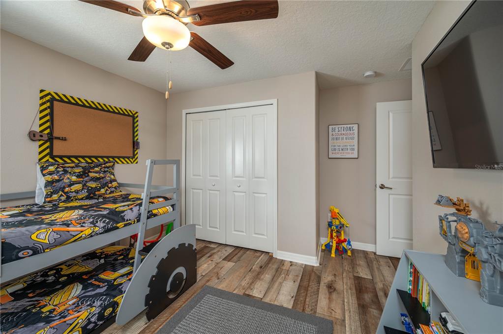 2958 Flying Blackbird Road Bartow, FL 33830 - Photo 20 of 28 a bedroom with a bed and wooden floor
