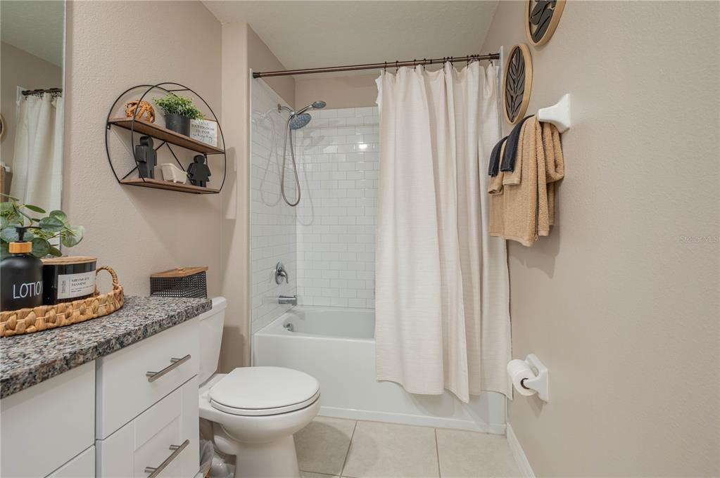 2958 Flying Blackbird Road Bartow, FL 33830 - Photo 22 of 28 a bathroom with a granite countertop sink toilet and shower