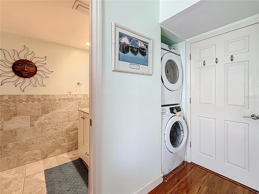 230 Medallion Boulevard, Unit G Madeira Beach, FL 33708 - Photo 25 of 38 a bathroom with a sink a washer and dryer