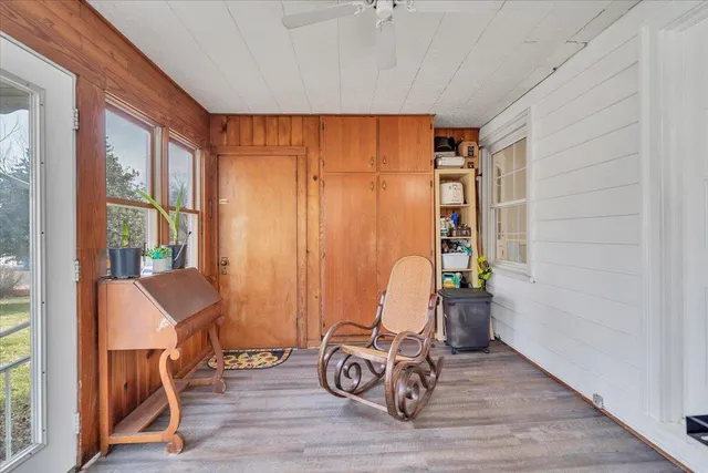 a view of workspace room with wooden floor and furniture