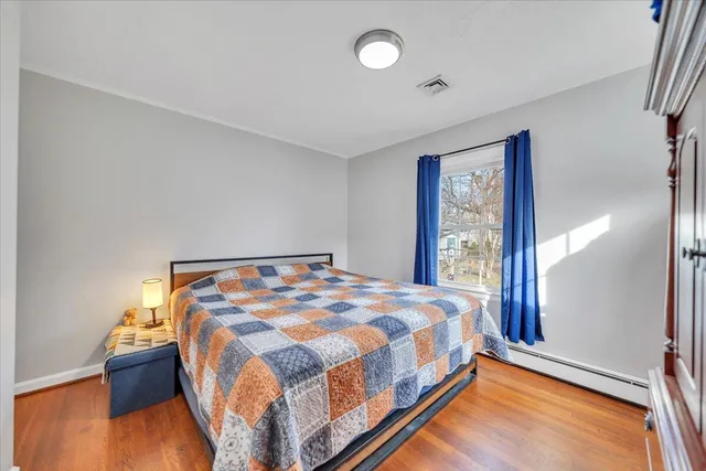 a bedroom with a bed and window