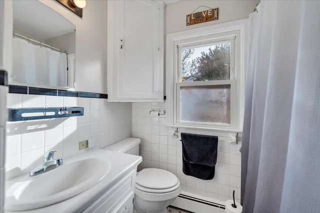 a bathroom with a toilet a sink and a window
