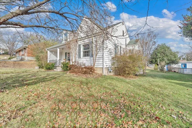 a front view of house with yard and swimming pool