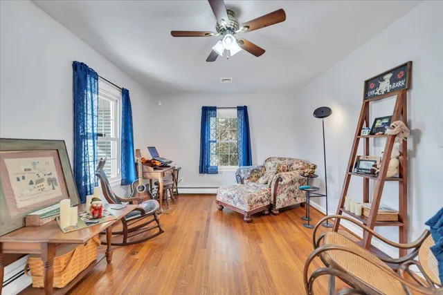 a living room with furniture and a wooden floor