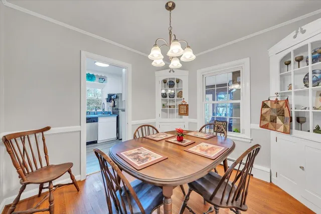 a view of a dining room with furniture wooden floor and chandelier
