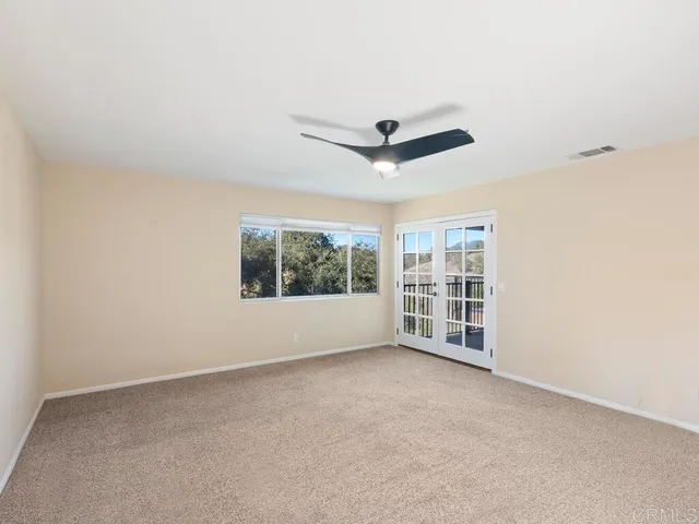 a living room with lots of furniture and view of potted plants
